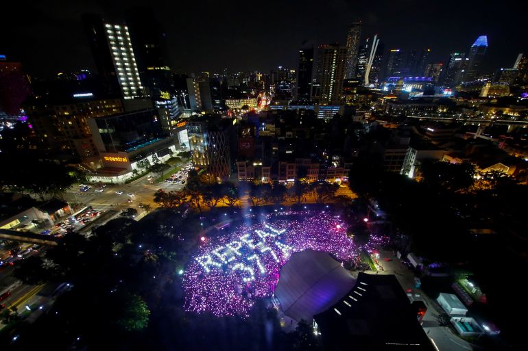 Participants of Pink Dot gather in a formation calling for the repeal of Section 377A of Singapore's Penal Code.