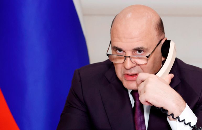 Russian Prime Minister Mikhail Mishustin attends a meeting on metals industries chaired by Russian President Vladimir Putin via video conference in Moscow, Russia, Monday, Aug. 1, 2022. (Dmitry Astakhov, Sputnik, Government Pool Photo via AP)