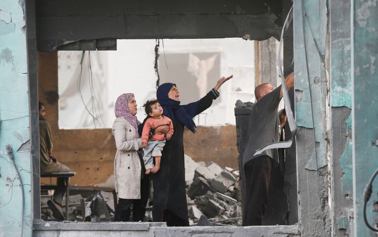 Palestinians react as they inspect the damage at a school sheltering displaced people, following an Israeli strike, in Jabalia refugee camp, in the northern Gaza Strip, May 12, 2025. REUTERS/Mahmoud Issa