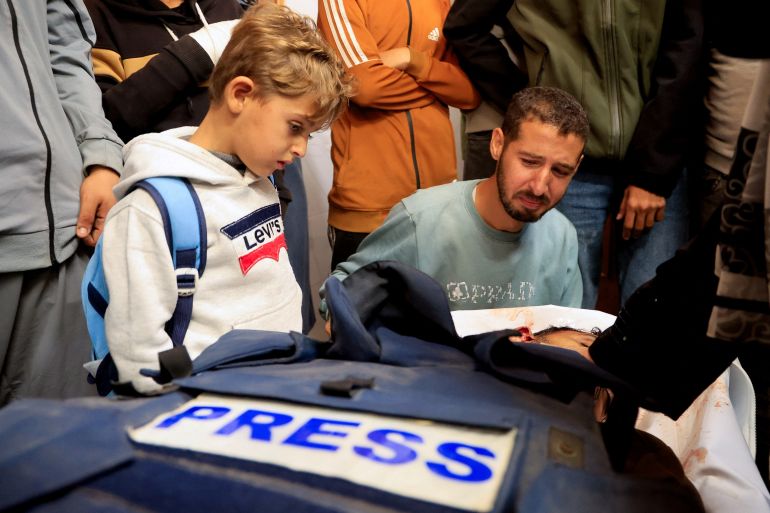 Mourners react next to the body of freelance Palestinian journalist Mahmoud Wadi, who was killed in an Israeli strike in the southern Gaza Strip, December 2, 2025. [File: Haseeb Alwazeer/Reuter]