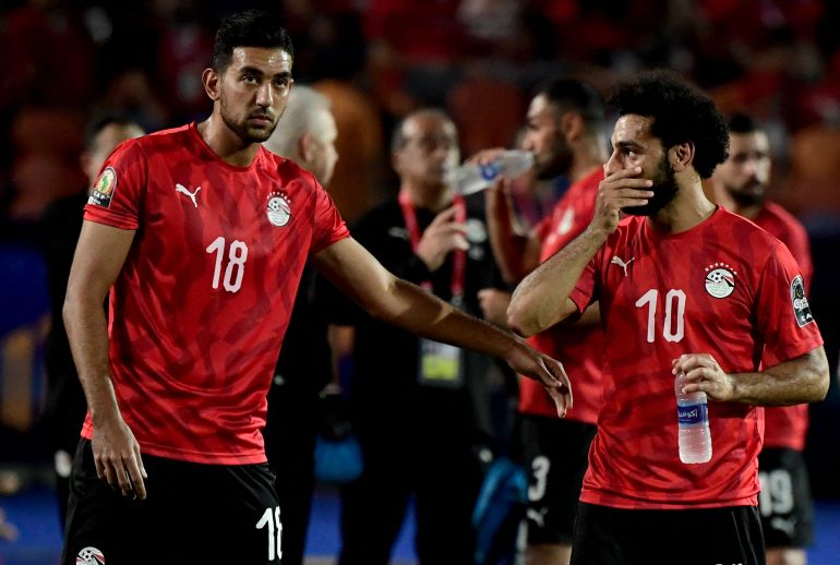 Egypt's forward Ahmed 'Kouka' Hassan and Mohamed Salah react.