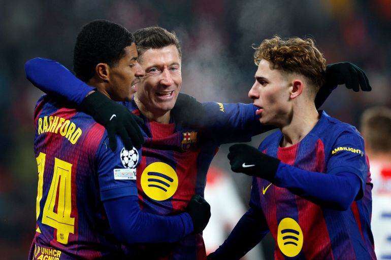 Barcelona's Robert Lewandowski celebrates scoring their fourth goal with FC Barcelona's Marcus Rashford and FC Barcelona's Fermin Lopez
