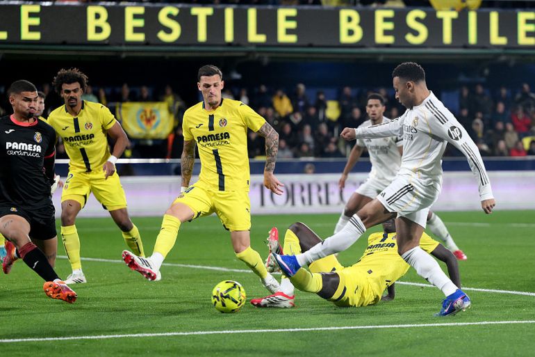 Kylian Mbappe of Real Madrid scores his team's first goal past Luiz Junior of Villarreal