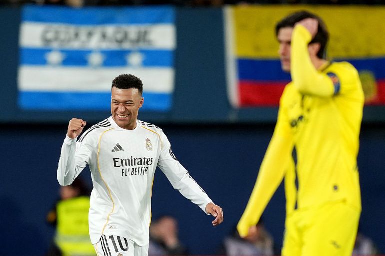 Kylian Mbappe of Real Madrid scores his team's first goal past Luiz Junior of Villarreal